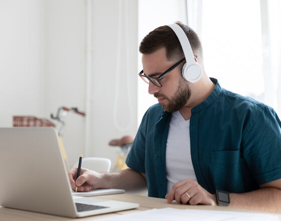 White man studying at computer